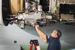 A man working on a aircraft engine.