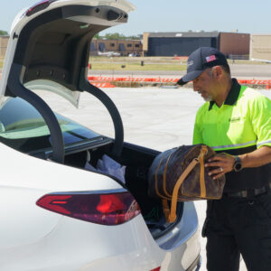 addison airport employee loading luxury luggage