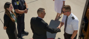 pilot shaking hands with jet passenger