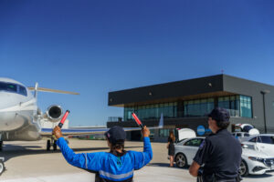 Aircraft marshaller or ramp agent waving jet down tarmac